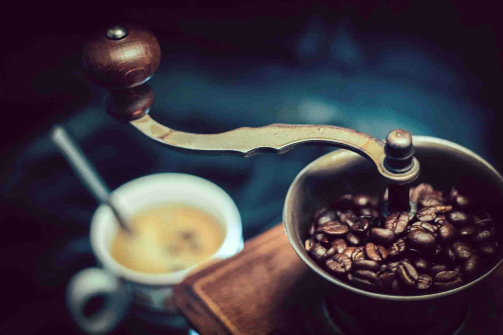 Burr Grinder Guide: Burr vs Blade, Conical vs Flat 6 Whole coffee beans next to a coffee grinder