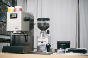 Home espresso setup with a Gaggia Classic espresso machine, a burr grinder and a tamper